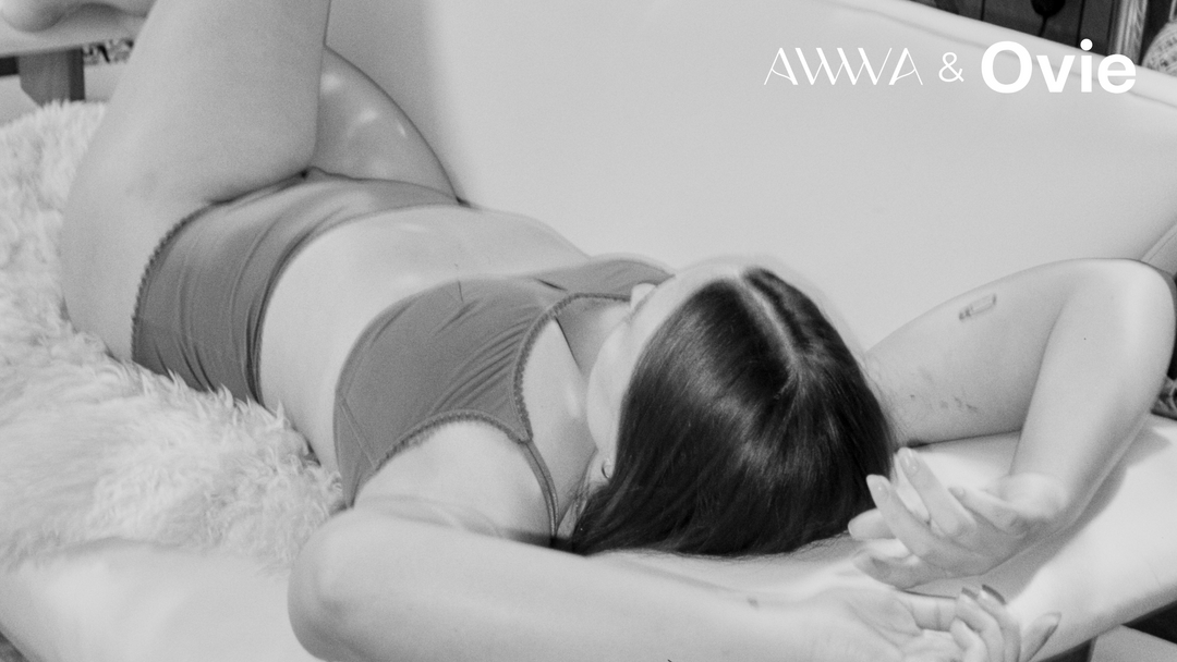 Black and white image of person lying down on a couch wearing AWWA underwear and bra. AWWA and Ovie logo in the top right hand corner.